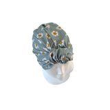 Floral patterned headscarf on a mannequin head against a white background