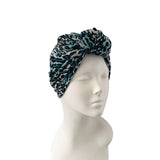 Leopard print headband on a mannequin head against a white background