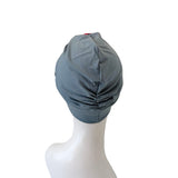 Gray turban on a mannequin head against a white background