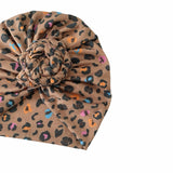 Leopard print headband with a knotted center on a white background