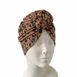 Leopard print headscarf on a mannequin head against a white background