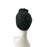 Black patterned headscarf on a mannequin head against a white background