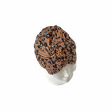 Patterned headscarf on a mannequin head against a white background