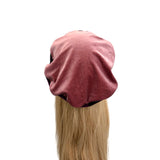Pink beanie on a mannequin head with blonde hair against a white background