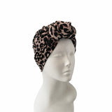 Leopard print headband on a mannequin head against a white background