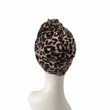 Leopard print headscarf on a mannequin head against a white background