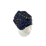 Navy blue scrub cap with colorful pattern on a mannequin head against a white background