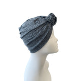 Leopard print headscarf on a mannequin head against a white background