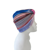 Colorful headscarf on a mannequin head against a white background
