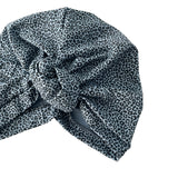 Leopard print headscarf with a knot on a white background