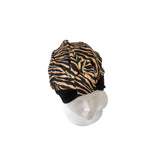 Zebra print headscarf on a mannequin head against a white background