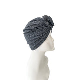 Black patterned headscarf on a mannequin head against a white background