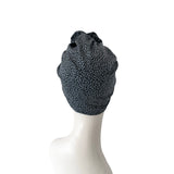 Black leopard print headscarf on a mannequin head against a white background