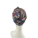 Floral patterned headscarf on a mannequin head against a white background