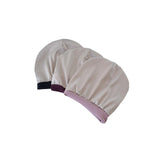 Two beige hairnets with purple and black accents on a white background