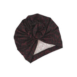 Dark patterned turban on a white background