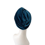 Blue headscarf on a mannequin head against a white background
