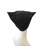 Black cat ears on a mannequin head against a white background