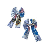 Two patterned hair bows on a white background
