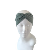 Green headband on a mannequin head against a white background