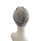 Gray headscarf on a mannequin head against a white background