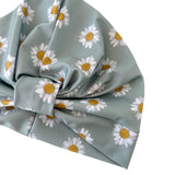 Gray fabric with white daisy patterns on a white background