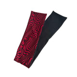 A pair of athletic compression sleeves shown folded, with one sleeve displaying a red and black wavy psychedelic pattern and the other showing a solid black fabric side, set against a plain white background.