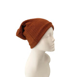 Brown knit beanie on a mannequin head against a white background
