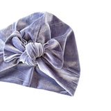Purple velvet head wrap with a knot on a white background