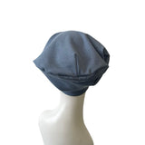 Blue beanie on a mannequin head against a white background
