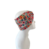 Floral patterned headband on a mannequin head against a white background
