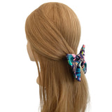 Mannequin head with long blonde hair wearing a colorful hair scrunchie on a white background