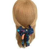 Colorful bow in hair on a mannequin head with a white background