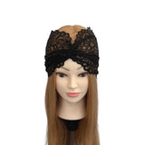 Black lace headband on a mannequin head with long brown hair against a white background