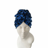 Blue patterned headscarf on a mannequin head against a white background