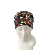 Decorative headband with a floral pattern on a mannequin head against a white background