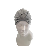 Gray headscarf on a mannequin head against a white background