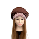 Mannequin head with a brown satin headscarf on a white background
