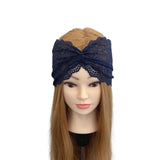 Navy lace headband on a mannequin head with long brown hair against a white background