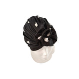 Black headscarf with floral design on a mannequin head against a white background