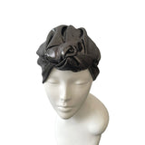 Gray headscarf on a mannequin head against a white background