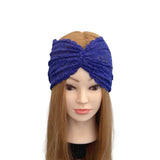 Blue knitted headband on a mannequin head with long brown hair against a white background