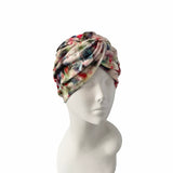 Colorful headscarf on a mannequin head against a white background