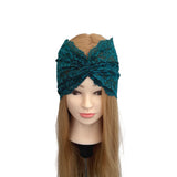Teal lace headband on a mannequin head with long brown hair against a white background