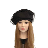 Black beret on a mannequin head with long blonde hair against a white background