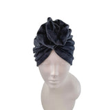 Dark gray turban on a mannequin head against a white background