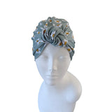 Floral patterned headscarf on a mannequin head against a white background