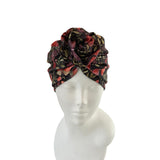 Floral patterned headscarf on a mannequin head against a white background