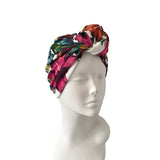 Colorful floral headscarf on a mannequin head against a white background