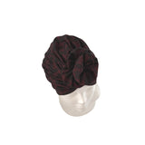 Dark red patterned headscarf on a mannequin head against a white background